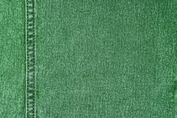 Denim jeans texture background. Texture of green colored cotton fabric with decorative seam. Stiched texture jean background. Fiber and fabric structurel. Wallpaper, banner, backdrop, header