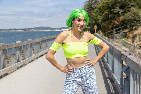 Pretty Asian woman wearing neon green shirt and wig hair