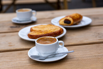 Close up of Coffee Cup and Bakery Goods on Table