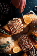 Hand with knife cutting traditional bread in Mexico, rosca de reyes. Mexican food.