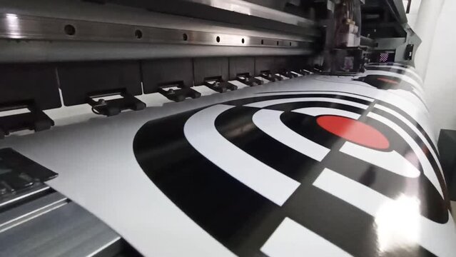 modern printer printing on wide format. Oracal photo printing. Head of printer Mimaki during foto printing process. printer prints photo of target for sticker