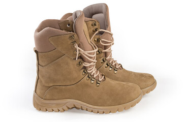 Pair of beige leather combat boots on a white background