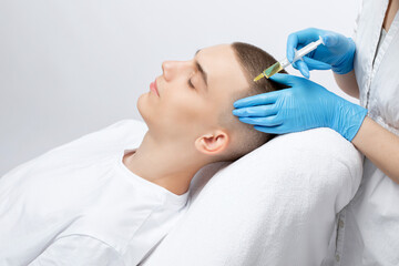 Cosmetologist does prp therapy of a handsome guy in beauty salon. Cosmetology concept.