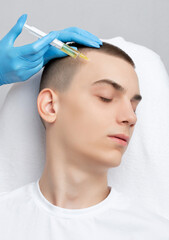 Cosmetologist does prp therapy of a handsome guy in beauty salon. Cosmetology concept.