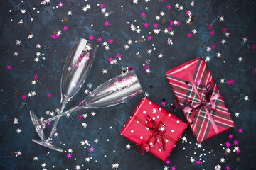Celebration background - top view of two chrystal champagne glasses and gift boxes
