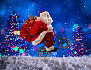 Santaclaus wheelie with bike to deliver fast christmas gifts - obrazy, fototapety, plakaty