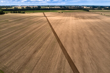 plowing farm after harvesting with vehicle