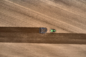 plowing farm after harvesting with vehicle