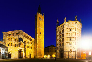 Fototapeta na wymiar Parma cathedral and baptistery illuminated at dusk and Piazza Duomo in Italy