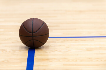 Basketball on hardwood court floor. Horizontal sport theme poster, greeting cards, headers, website and app