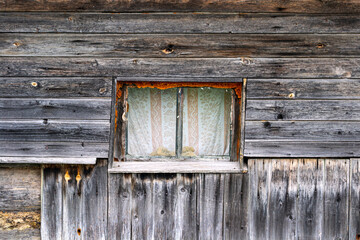 A small window in an old wooden bathhouse in the village.