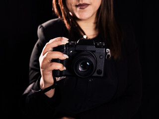 woman photographer close up camera on black background 