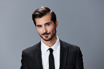 Portrait of a business man with a natural smile on a gray background in a business suit. Business portrait of a stylish man