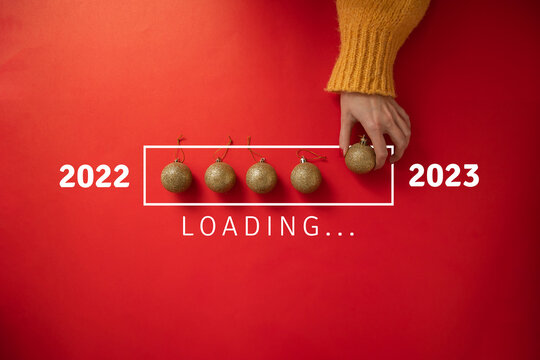 New Year loading. 2023 is coming. Gold Christmas decorations on loading scale. from 2022 to 2023. 