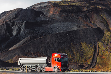 Truch driving from Volcanic red stone quarry in Iceland
