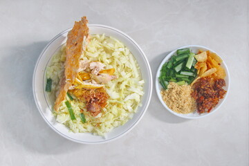 Soto Ayam (yellow chicken soup) with tempeh crackers is a popular traditional food in Indonesia 