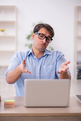 Young male employee working in the office