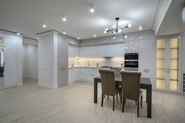Interior of new spacious white kitchen after renovation in studio apartmen