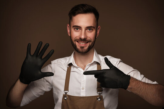 Manicur master man in working form in black gloves on hands. Nail photo content