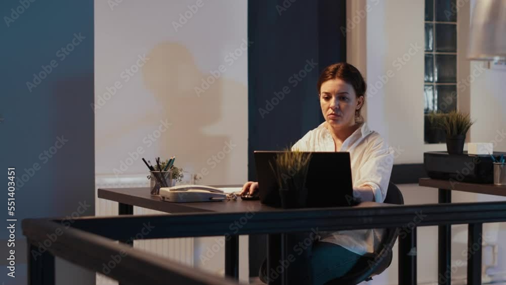 Poster startup employee working late at night in company office, using laptop to plan software presentation