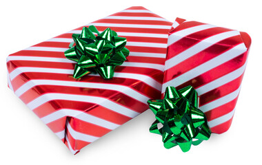 Two Christmas gift boxes in striped red and white paper and green bows