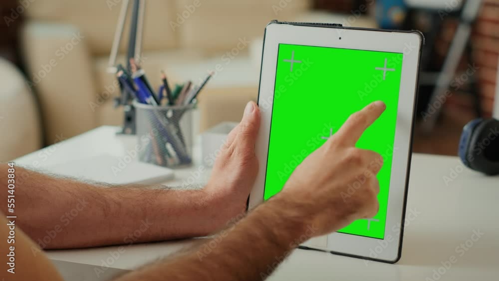 Poster office employee vertically holding gadget with greenscreen display, blank chroma key template and is