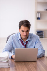 Young male employee working in the office