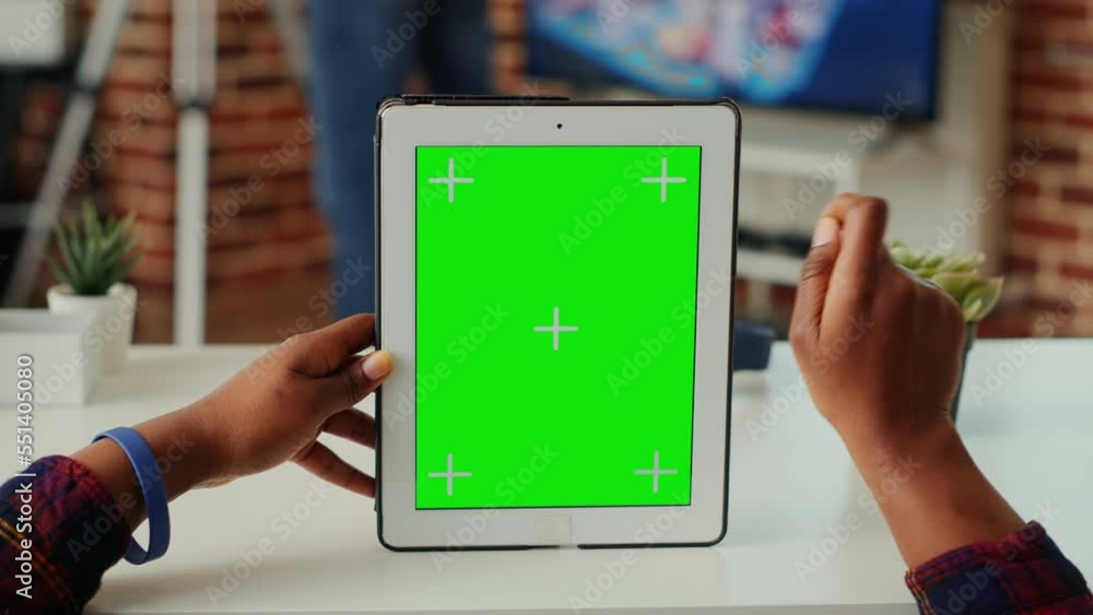 Poster woman analyzing greenscreen on isolated display, vertically holding digital tablet with blank backgr