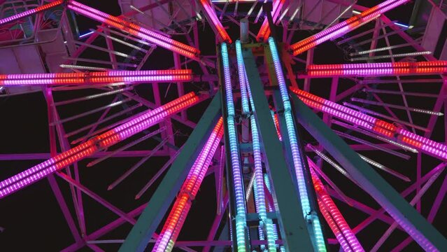 Ferris wheel at night of colorful with outdoor round rotation st Amusement Park, The annual temple event has activities, neon light