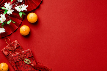 Happy Chinese New Year 2023 concept. Oriental asian style paper fans, orange tangerines, money...