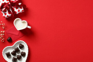 Valentine's day background with gift box, heart shaped candy, coffee cup, red paper envelope and...