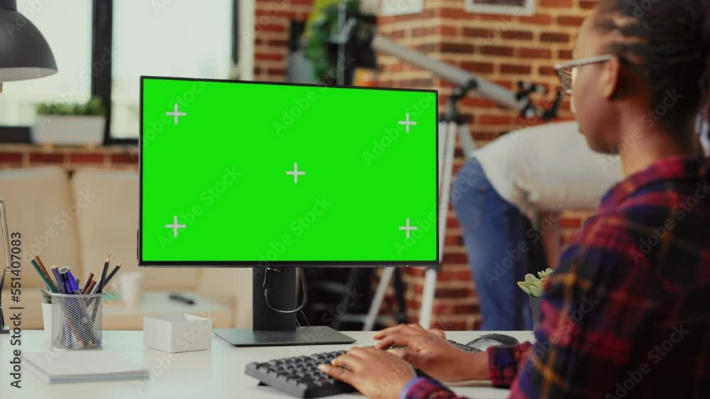 Aufkleber african american woman using monitor to work with greenscreen template on isolated display, looking 