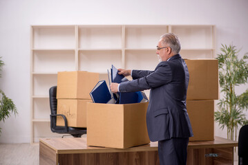 Old male employee in office relocation concept