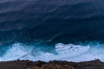 ocean surf waves at sunset view from above