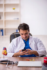 Young male doctor in telemedicine concept