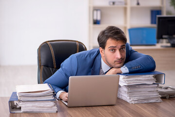 Young male employee working in the office