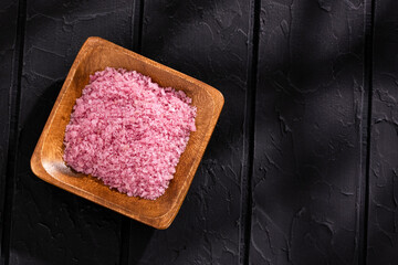 Fine red wine salt crystals in the wooden bowl