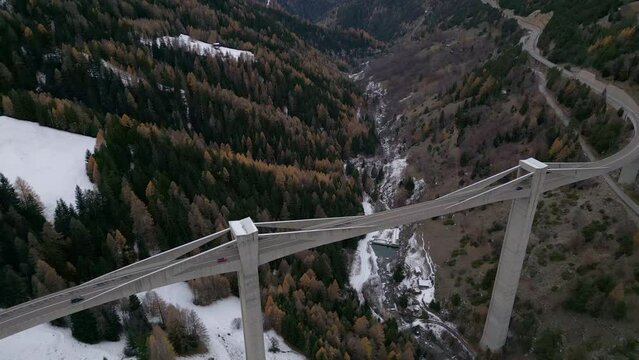 A large bridge connects a valley in the Swiss mountains. It is the Ganter Bridge on the pass road to the Simplon Pass in the canton of Valais. Aerial Shot