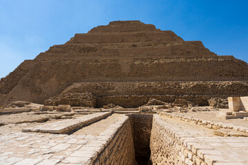 Step pyramid of Djoser funerary complex (necropolis) in Saqqara, Egypt.  Travel and history. - obrazy, fototapety, plakaty