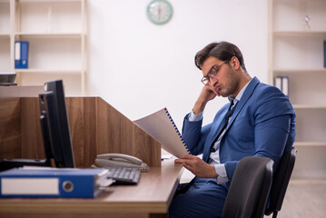 Young male employee working in the office
