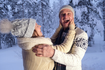 happy mature couple, man 60 years old and woman 55 years old are have fun, hugging in winter...