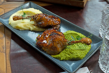 Duck drumstick with home made maple syrup on two kinds of puree