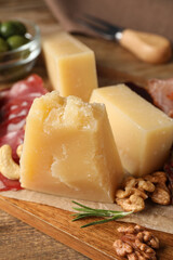 Snack platter with parmesan cheese on wooden table, closeup