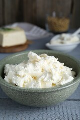 Delicious tofu cream cheese in bowl on grey wooden table