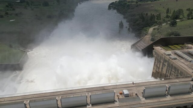 Aerial flyover as hydroelectric dam releases flood water into river
