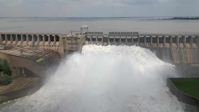 Aerial retreats from hydroelectric dam releasing water during flood