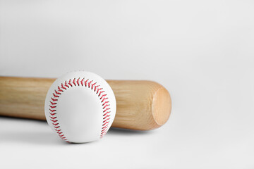 Wooden baseball bat and ball on white background. Sports equipment