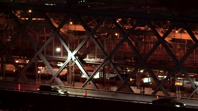Subway crosses Williamsburg bridge from Manhattan towards Brooklyn at night
