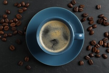 Cup of aromatic coffee and beans on grey table, top view