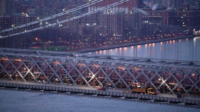 Detail of Williamsburg Bridge viewed during late evening against the background of East River and Manhattan